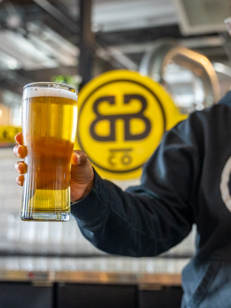 Brockton Beer Company employee holding a pint of beer