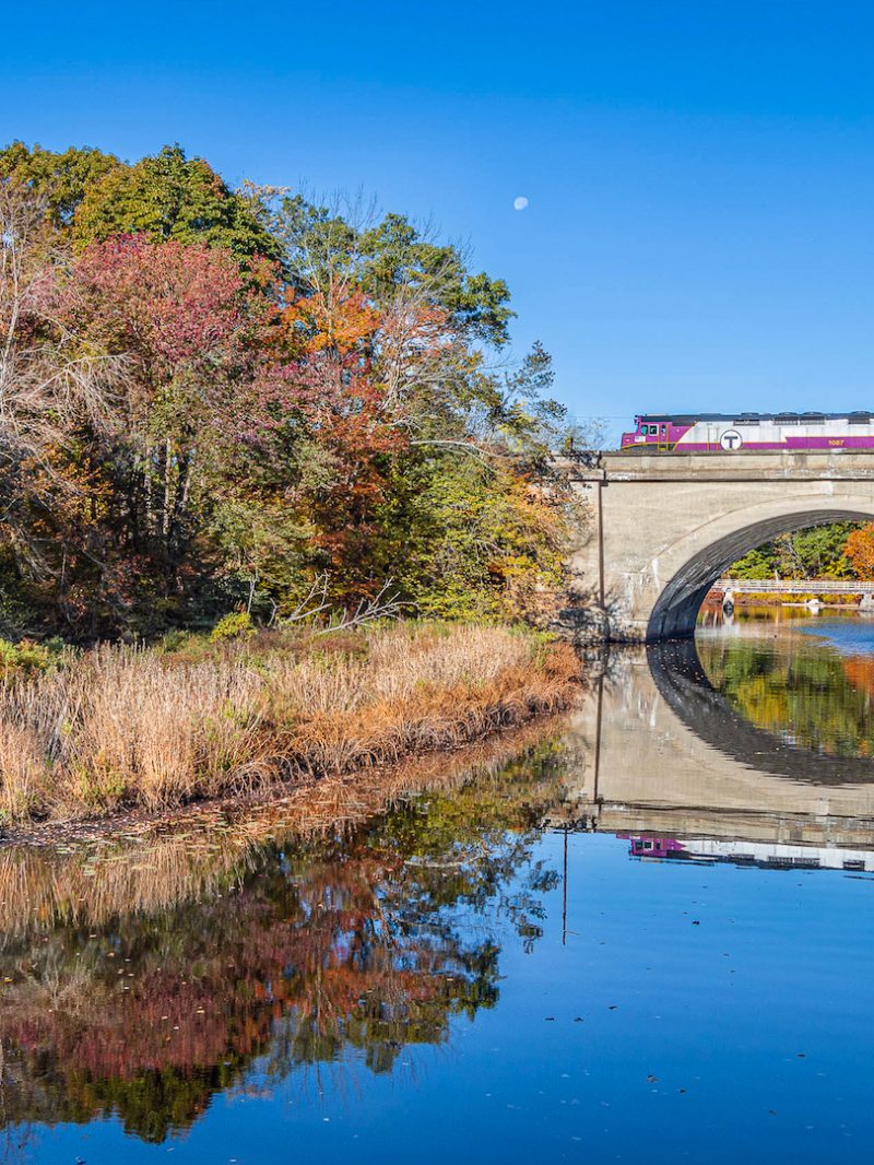 Commuter Rail train going over bridge during Fall