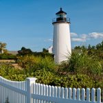 White Picket Fence by Newburyport Harbor Lighthouse In Massachusetts.