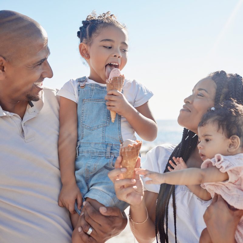 Cape Cod family, beach and ice cream with children and parents on sand by the sea or ocean during summer together. Kids, travel and relax with a mother, father and daughter siblings bonding in nature