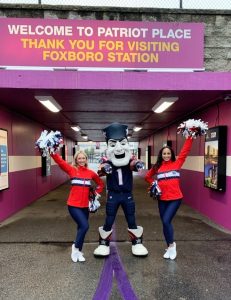 Pat the Patriot with Patriots cheerleaders at Foxboro Commuter Rail station