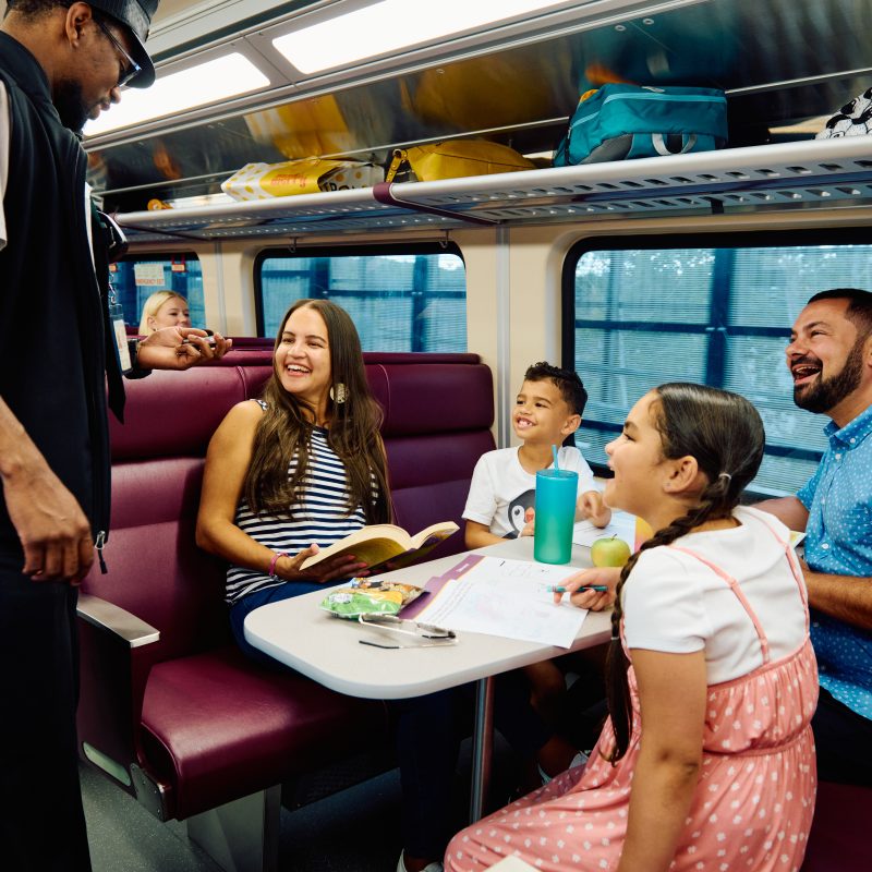 Family on train speaking with conductor