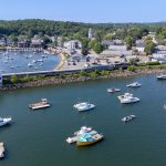 Commuter Rail train crossing bridge over water approaching the Manchester-by-the-Sea Station