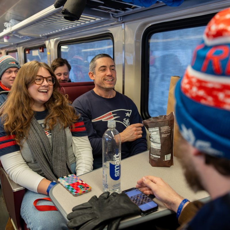 Patriots fans on board a train heading to Gillette Stadium