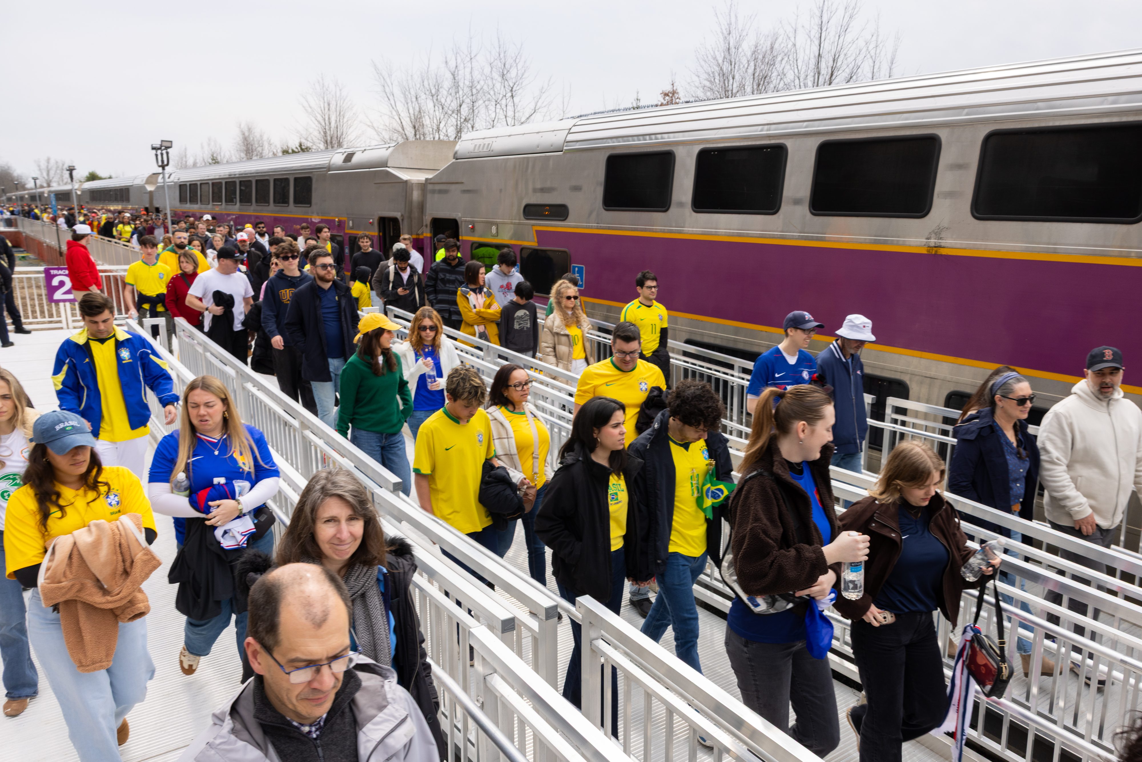 soccer fans boarding the Commuter Rail before heading to watch a match